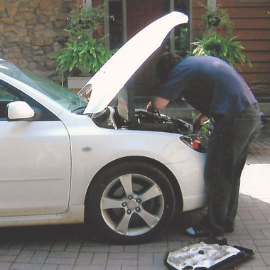 mechanic Michael Schmidt repairing a car